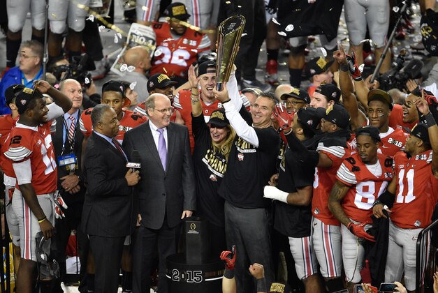 Jan 12, 2015; Arlington, TX, USA; Ohio State Buckeyes head coach Urban Meyer holds up the championship trophy after the Buckeyes defeat the Oregon Ducks at AT&T Stadium. The Buckeyes defeated the Ducks 42-20. Mandatory Credit: Jerome Miron-USA TODAY Sports