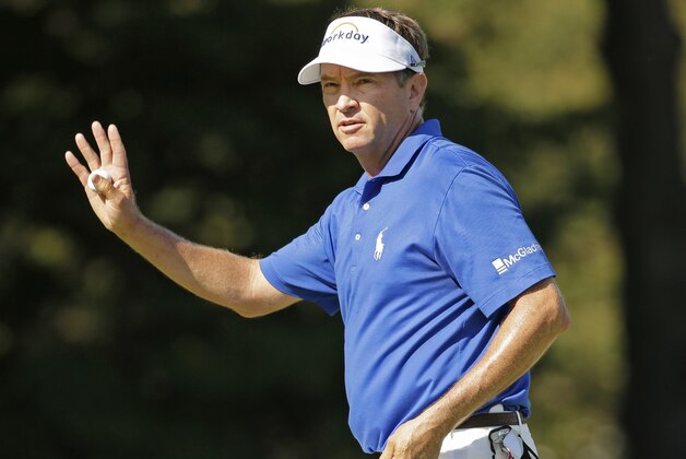 Davis Love III waves to the crowd on the 18th hole during the final round of the Wyndham Championship golf tournament at Sedgefield Country Club in Greensboro, N.C., Sunday, Aug. 23, 2015. Love won the tournament. (AP Photo/Chuck Burton)