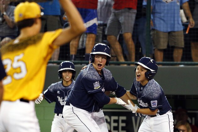 Lewisberry, Pa.'s Adam Cramer, right, and Cole Wagner, center, celebrate after scoring on a double by Jaden Henline off Taylors, S.C.'s Ryan Soug as Taylor's Alex Edmondson (25) walks off the field after of a baseball game at the Little League World Series in South Williamsport, Pa., Sunday, Aug. 23, 2015. Lewisberry won 9-8. (AP Photo/Gene J. Puskar)