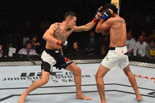 SASKATOON, SK - AUGUST 23:  (L-R) Max Holloway of the United States punches Charles Oliveira of Brazil in their featherweight bout during the UFC event at the SaskTel Centre on August 23, 2015 in Saskatoon, Saskatchewan, Canada. (Photo by Jeff Bottari/Zuffa LLC/Zuffa LLC via Getty Images)