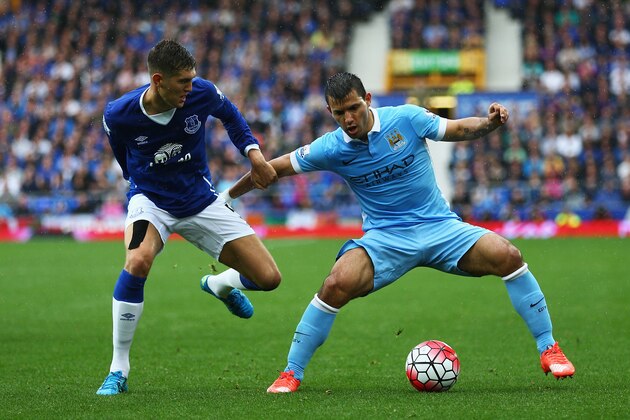 LIVERPOOL, ENGLAND - AUGUST 23:  John Stones of Everton challenges Sergio Aguero of Manchester City during the Barclays Premier League match between Everton and Manchester City at Goodison Park on August 23, 2015 in Liverpool, England.  (Photo by Clive Brunskill/Getty Images)