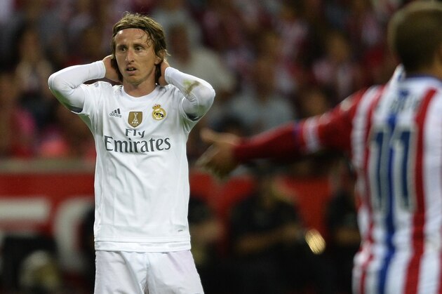 Real Madrid's Croatian midfielder Luka Modric reacts during the Spanish league football match Sporting Gijon vs Real Madrid CF at the El Molinon stadium in Gijon on August 23, 2015.   AFP PHOTO/ MIGUEL RIOPA        (Photo credit should read MIGUEL RIOPA/AFP/Getty Images)