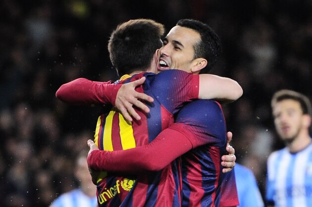 FC Barcelona's Pedro Rodriguez, right, celebrates after scoring with teammate Lionel Messi, from Argentina, during a Spanish La Liga soccer match against Malaga at the Camp Nou stadium in Barcelona, Spain, Sunday, Jan. 26, 2014. (AP Photo/Manu Fernandez)