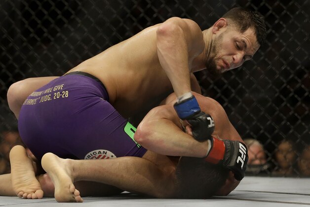 Jorge Masvidal, top, punches Daron Cruickshank during a lightweight mixed martial arts bout at a UFC on Fox event in San Jose, Calif., Saturday, July 26, 2014. Masvidal won by unanimous decision. (AP Photo/Jeff Chiu)