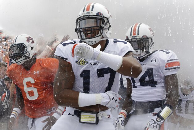 Auburn quarterback's Jeremy Johnson (6) Ben Durand (17) and defensive back Stephen Roberts (14) run out onto the field before their spring NCAA college football game, Saturday, April 18, 2015, in Auburn, Ala. (AP Photo/Brynn Anderson)