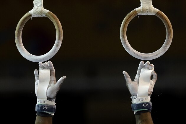 The United States' Donnell Whittenburg reaches for the rings before starting his routine during artistic gymnastics competition in the Pan Am Games in Toronto, Tuesday, July 14, 2015. Whittenburg won the silver medal in the event. (AP Photo/Gregory Bull)