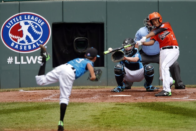 Dominican Republic's Yaniel De Jesus Arias drives in a run with a single off Portland, Oregon's Jackson Farr (5) and Cooper Shaw catching during the second inning of a consolation baseball game at the Little League World Series tournament in South Williamsport, Pa., Monday, Aug. 24, 2015. (AP Photo/Gene J. Puskar)
