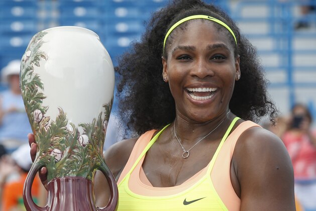Serena Williams, of the United States, holds the Rookwood Cup after defeating Simona Halep, of Romania, in the women's final at the Western & Southern Open tennis tournament, Sunday, Aug. 23, 2015, in Mason, Ohio. Williams defeated Halep 6-3, 7-6 (5). (AP Photo/John Minchillo)