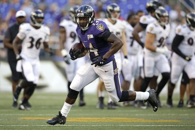 Baltimore Ravens running back Lorenzo Taliaferro rushes the ball during NFL football training camp, Monday, Aug. 3, 2015, in Baltimore. (AP Photo/Patrick Semansky)