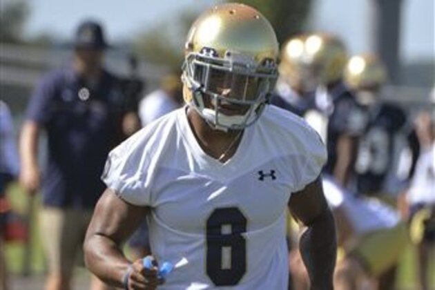 In this Friday, Aug. 7, 2015, photo, Notre Dame cornerback KeiVarae Russell loosens up up during the first practice of the season for the NCAA college football team in Culver, Ind. Russell is more worried about learning to trust his instincts again than knocking off rust as he returns to the football field after a season-long banishment. (AP Photo/Joe Raymond)