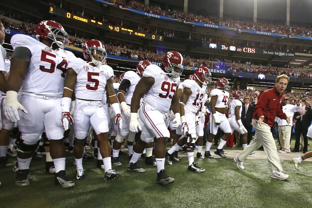 Alabama head coach Nick Saban leads the team out onto the field for the start of an NCAA college football game Saturday, Dec. 6, 2014, in Atlanta, Ga. (AP Photo/Butch Dill)