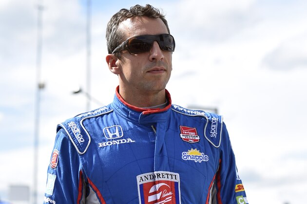 Justin Wilson, of England, walks on pit road during qualifying for Sunday's Pocono IndyCar 500 auto race, Saturday, Aug. 22, 2015, in Long Pond, Pa. Wilson was injured during Sunday's race and air lifted to the hospital. (AP Photo/Derik Hamilton)