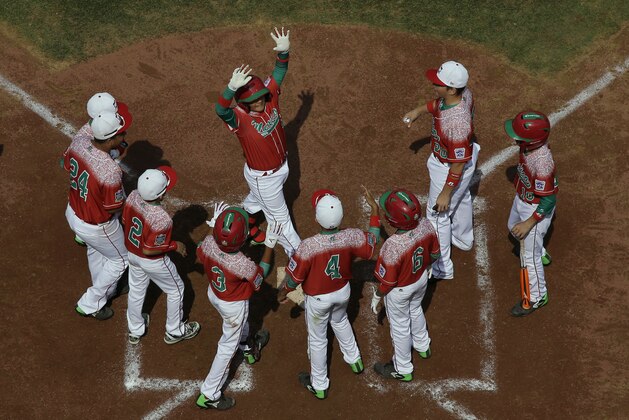 Mexico's Damian Garcia, top center, celebrates with teammates after hitting a two-run home run off Australia's Luke Krkovski during the second inning of an International elimination baseball game at the Little League World Series, Monday, Aug. 24, 2015, in South Williamsport, Pa. Mexico won 14-3 in four innings. (AP Photo/Matt Slocum)