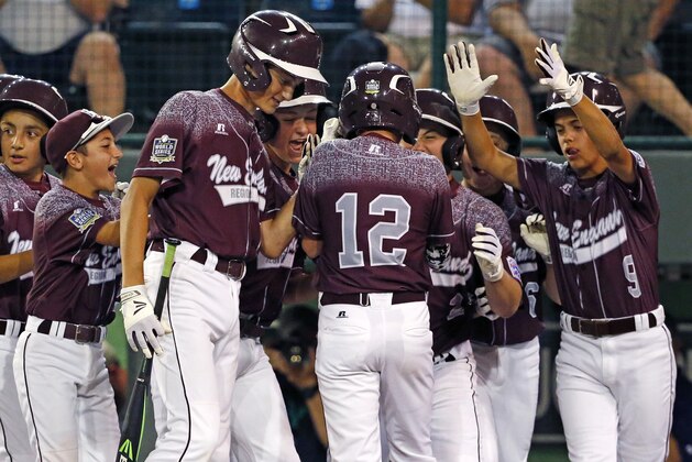 Cranston, Rhode Island's Caleb Harris (12) is greeted by teammates after hitting a solo-home run off Bonita, California's Levi Mendez during the first inning of an United States elimination baseball game at the Little League World Series tournament in South Williamsport, Pa., Monday, Aug. 24, 2015. (AP Photo/Gene J. Puskar)