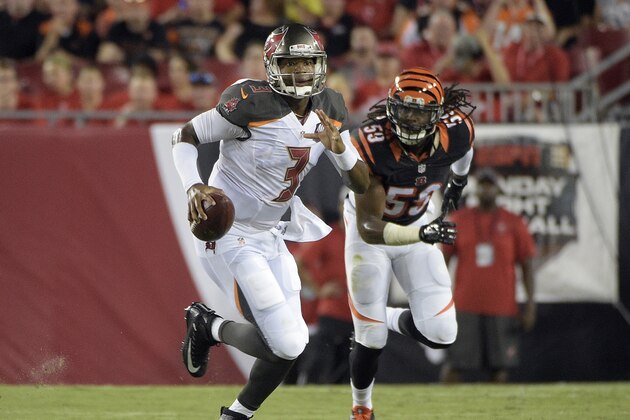 Tampa Bay Buccaneers quarterback Jameis Winston (3) scrambles away from Cincinnati Bengals outside linebacker Emmanuel Lamur (59) during the first quarter of an NFL preseason football game Monday, Aug. 24, 2015, in Tampa, Fla. (AP Photo/Phelan M. Ebenhack)