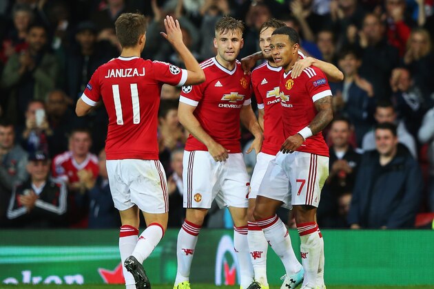 MANCHESTER, ENGLAND - AUGUST 18:  Memphis Depay (R) of Manchester United celebrates scoring his team's second goal with team mates during the UEFA Champions League Qualifying Round Play Off First Leg match between Manchester United and Club Brugge at Old Trafford on August 18, 2015 in Manchester, England.  (Photo by Alex Livesey/Getty Images)