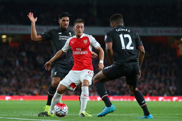 LONDON, ENGLAND - AUGUST 24:  Mesut Ozil of Arsenal tries to get past Emre Can and Joe Gomez of Liverpool during the Barclays Premier League match between Arsenal and Liverpool at the Emirates Stadium on August 24, 2015 in London, United Kingdom.  (Photo by Catherine Ivill - AMA/Getty Images)