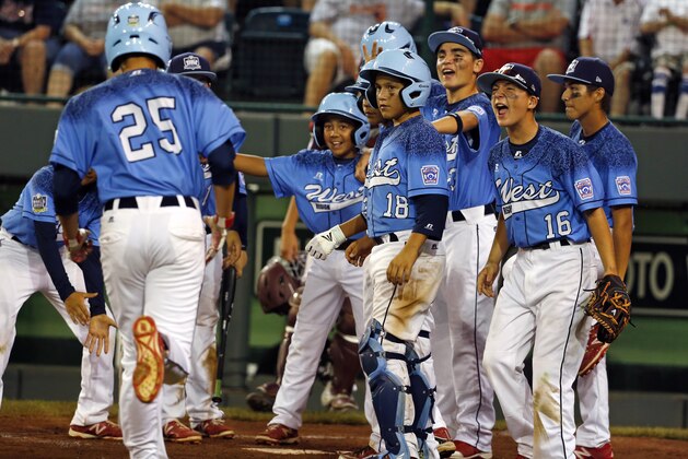 Dante Schmid (25), of  Bonita, Calif., is greeted by teammates after hitting a solo-home run  in the sixth inning of an United States elimination baseball game at the Little League World Series tournament in South Williamsport, Pa., Monday, Aug. 24, 2015. Bonita, Calif., won 10-3. (AP Photo/Gene J. Puskar)