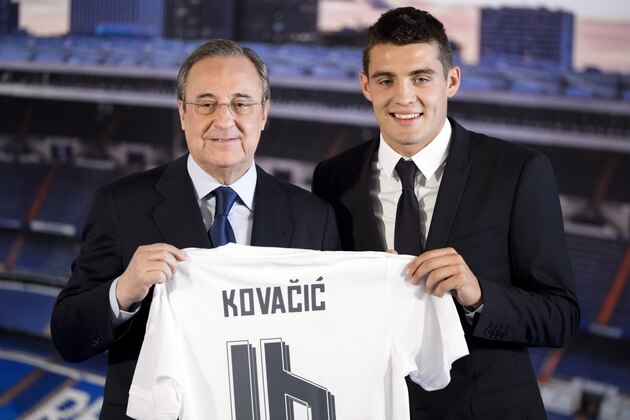Real Madrid's new player Croatian Mateo Kovacic (R) and Real Madrid's president Florentino Perez hold Kovacic's new jersey during his official presentation at the Santiago Bernabeu stadium in Madrid on August 19, 2015.  AFP PHOTO / DANI POZO        (Photo credit should read DANI POZO/AFP/Getty Images)