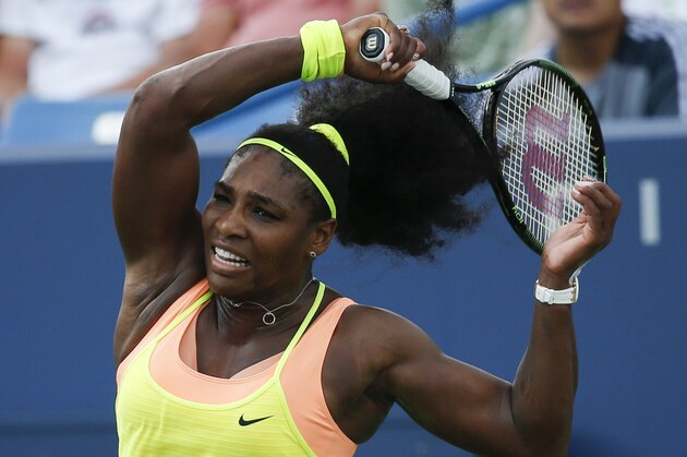 Serena Williams returns the ball to Simona Halep, of Romania, during a final match at the Western & Southern Open tennis tournament, Sunday, Aug. 23, 2015, in Mason, Ohio. Williams defeated Halep 6-3, 7-6 (5). (AP Photo/John Minchillo)