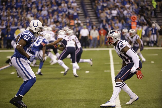 New England Patriots cornerback Darrelle Revis works against Indianapolis Colts wide receiver Reggie Wayne during the first half of an NFL football game in Indianapolis, Sunday, Nov. 16, 2014. (AP Photo/AJ Mast)