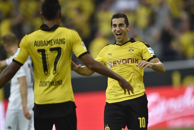 Dortmund's Henrikh Mkhitaryan, right, celebrates after scoring the third goal of the game assisted by teammate Pierre-Emerick Aubameyang, left, during the German Bundesliga soccer match between Borussia Dortmund and Borussia Moenchengladbach in Dortmund, Germany, Saturday, Aug. 15, 2015. (AP Photo/Martin Meissner)