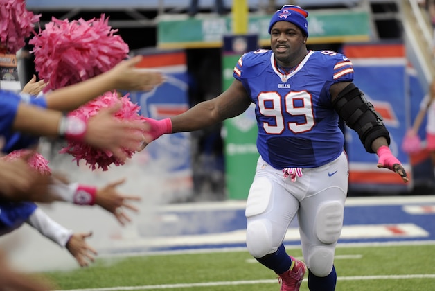 Buffalo Bills defensive tackle Marcell Dareus greets cancer survivors at the start of the NFL football game against the Cincinnati Bengals on Sunday, Oct. 13, 2013, in Orchard Park, N.Y. (AP Photo/Gary Wiepert)