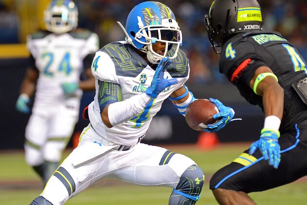 Jan 2, 2015; St. Petersburg, FL, USA; Team Highlight wide receiver Terry Godwin (4) attempts to break the tackle of Team Armour defensive back Micah Abermathy (4) during the second half of the 2015 Under Armour All-America Game at Tropicana Field. Team Highlight defeated Team Armour  46-6. Mandatory Credit: Jonathan Dyer-USA TODAY Sports