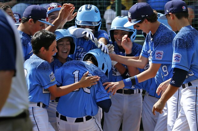 Bonita, California's Nick Maldonado (18) leaps on home plate as he is swarmed by teammates after hitting a grand slam off Bowling Green, Kentucky's Ty Bryant during the third inning of a baseball game in United States pool play at the Little League World Series tournament in South Williamsport, Pa., Friday, Aug. 21, 2015. The West won 14-2. (AP Photo/Gene J. Puskar)