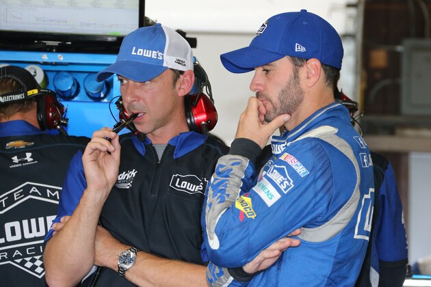 Jimmie Johnson and crew chief Chad Knaus talk before a practice session Friday, Aug. 14, 2015 for Sunday's NASCAR Sprint Cup series auto race at Michigan International Speedway in Brooklyn, Mich.  (AP Photo/Bob Brodbeck)