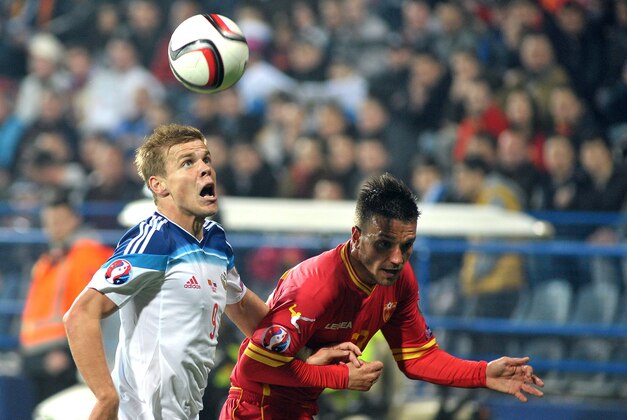 Russia's Aleksandr Kokorin, left challenges for the ball with Montenegro's Marko Simic during the Euro 2016 Group G qualifying soccer match between Montenegro and Russia, at the City Stadium in Podgorica, Montenegro, Friday, March 27, 2015. (AP Photo/Risto Bozovic)
