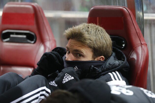 Real Madrid's Asier Illarramendi protects himself from the cold while sitting on the reserve bench during a round of 16,1st leg, Copa del Rey soccer match at the Vicente Calderon stadium in Madrid, Spain, Wednesday Jan. 7, 2015. (AP Photo/Paul White)