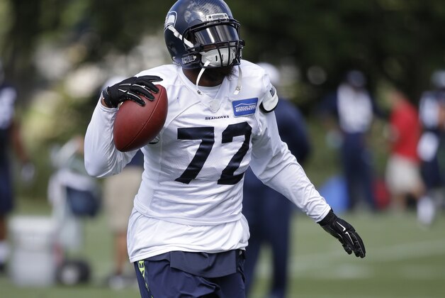 Seattle Seahawks' Michael Bennett walks at an NFL football training camp Thursday, Aug. 6, 2015, in Renton, Wash. (AP Photo/Elaine Thompson)