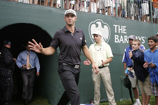 Dustin Johnson emerges back onto the 18th green after signing his score card  after winning The Barclays golf tournament, Saturday, Aug. 27, 2011, in Edison, N.J. (AP Photo/Rich Schultz)
