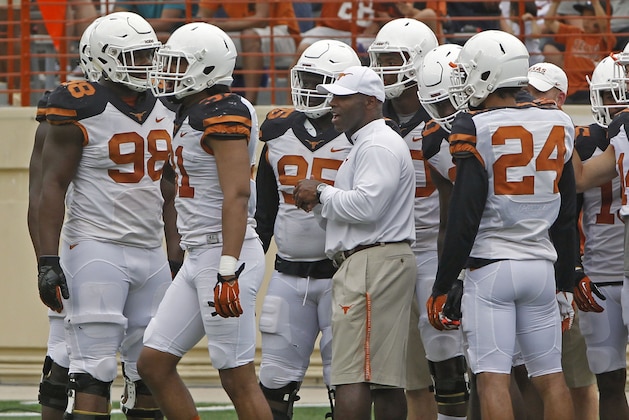 Texas head coach Charlie Strong stands with his team during the first quarter of Texas' Orange and White spring NCAA college football game, Saturday, April 18, 2015, in Austin, Texas. (AP Photo/Michael Thomas)