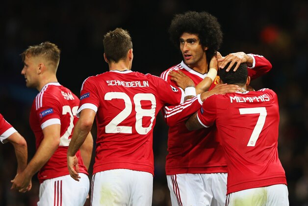 MANCHESTER, ENGLAND - AUGUST 18:  Marouane Fellaini of Manchester United celebrates scoring his team's third goal with Morgan Schneiderlin and Memphis Depay during the UEFA Champions League Qualifying Round Play Off First Leg match between Manchester United and Club Brugge at Old Trafford on August 18, 2015 in Manchester, England.  (Photo by Alex Livesey/Getty Images)