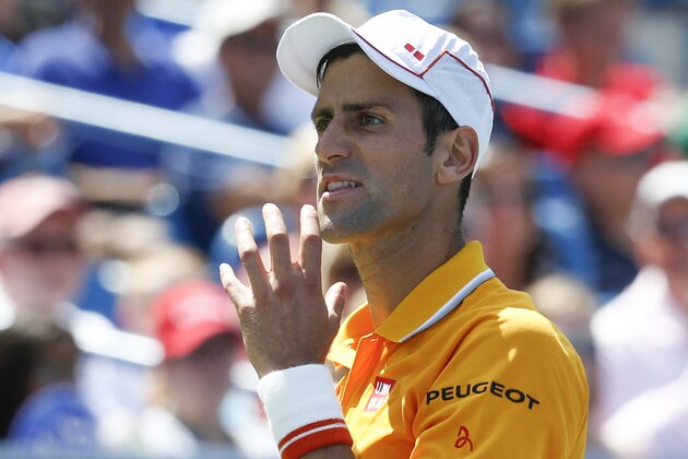 Novak Djokovic, of Serbia, reacts during a match against Alexandr Dolgopolov at the Western & Southern Open tennis tournament, Saturday, Aug. 22, 2015, in Mason, Ohio. Djokovic won4-6, 7-6 (5), 6-2. (AP Photo/John Minchillo)