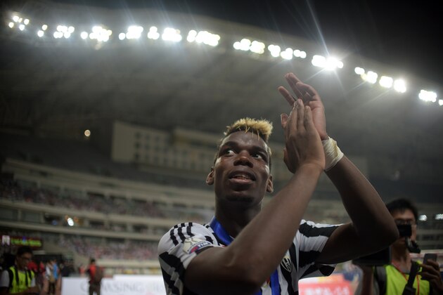 Juventus French midfileder Paul Pogba celebrates his team victory after the Italian Super Cup final football match between Juventus and Lazio in Shanghai on August 8, 2015. Juventus defeated Lazio 2:0.
AFP PHOTO / JOHANNES EISELE        (Photo credit should read JOHANNES EISELE/AFP/Getty Images)