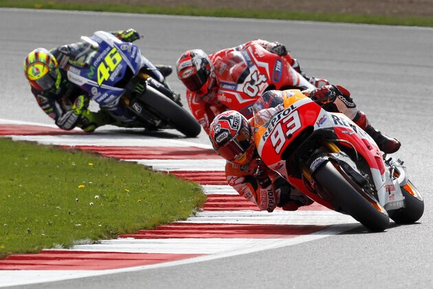 Repsol Honda Team rider Spanish Marc Marquez takes a turn with his Honda during the MotoGP race at the motorcycling British Grand Prix at Silverstone in Northamptonshire, southern England, on August 31, 2014. AFP PHOTO / IAN KINGTON        (Photo credit should read IAN KINGTON/AFP/Getty Images)