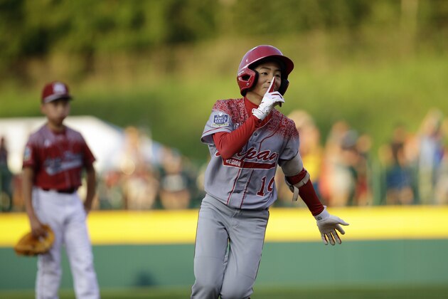 Japan's Kengo Tomita celebrates after hitting a home run during the first inning of an International pool play baseball game against Taiwan at the Little League World Series, Friday, Aug. 21, 2015, in South Williamsport, Pa. Japan won 7-5. (AP Photo/Matt Slocum)