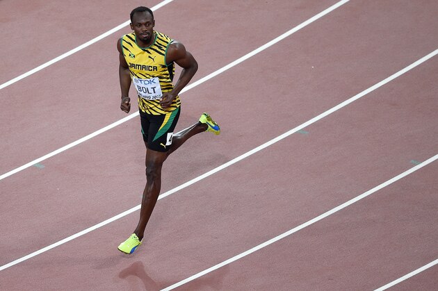 Jamaica's Usain Bolt reacts after competing in a heat of the men's 200 metres athletics event at the 2015 IAAF World Championships at the 'Bird's Nest' National Stadium in Beijing on August 25, 2015. AFP PHOTO / JOHANNES EISELE        (Photo credit should read JOHANNES EISELE/AFP/Getty Images)