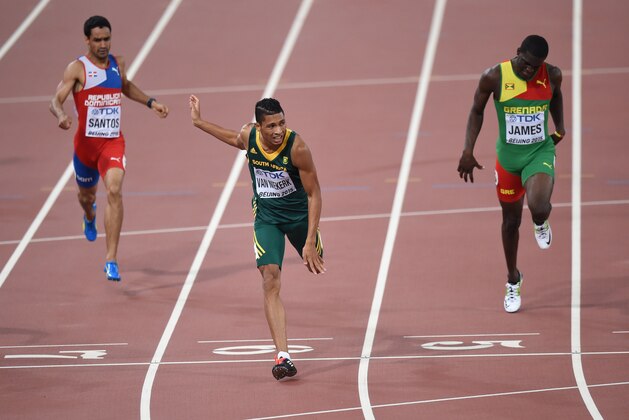 (L-R) Dominican Republic's Luguelin Santos, South Africa's Wayde Van Niekerk and Grenada's Kirani James compete in the final of the men's 400 metres athletics event at the 2015 IAAF World Championships at the 'Bird's Nest' National Stadium in Beijing on August 26, 2015.  AFP PHOTO / PEDRO UGARTE        (Photo credit should read PEDRO UGARTE/AFP/Getty Images)