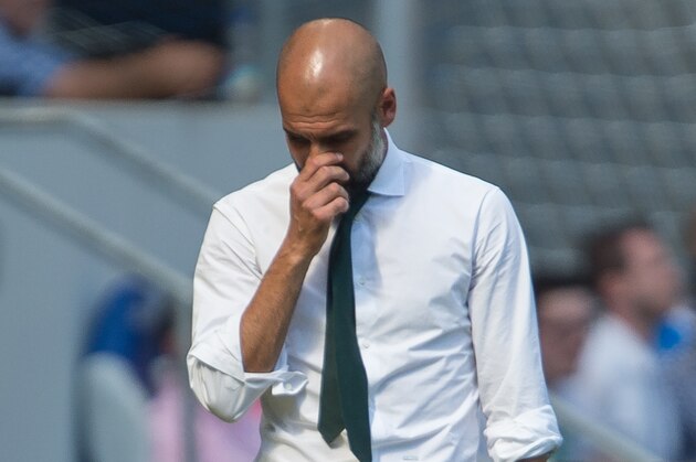 Bayern coach Pep Guardiola touches his face during the Germany Soccer Bundesliga match between TSG Hoffenheim and Bayern Munich in Sinsheim, southern Germany, Saturday Aug. 22, 2015. (AP Photo/Daniel Maurer)