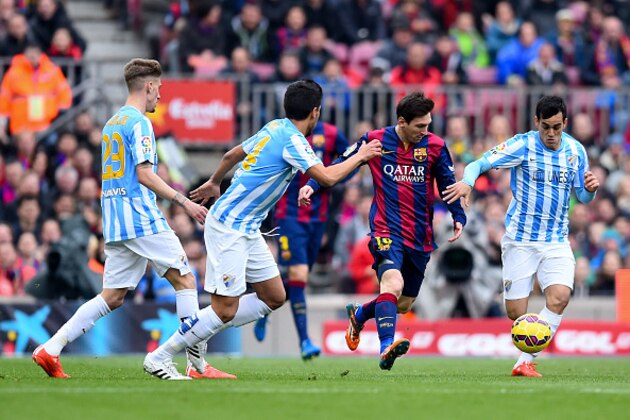 BARCELONA, SPAIN - FEBRUARY 21:  Lionel Messi of FC Barcelona competes for the ball against Malaga CF players during the La Liga match between FC Barcelona and Malaga CF at Camp Nou on February 21, 2015 in Barcelona, Spain.  (Photo by David Ramos/Getty Images)