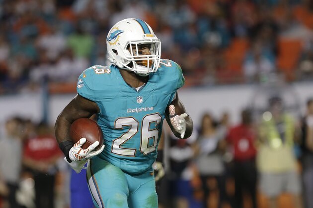 Miami Dolphins running back Lamar Miller runs for yardage during the second half of an NFL football game against the Buffalo Bills, Thursday, Nov. 13, 2014 in Miami Gardens, Fla. The Dolphins defeated the Bills 22-9. (AP Photo/Alan Diaz)