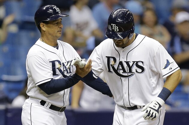 Tampa Bay Rays' Curt Casali, right, is held up briefly by third base coach Charlie Montoyo after injuring himself running around the bases after hitting a home run off Minnesota Twins relief pitcher Neal Cotts during the fifth inning of a baseball game Tuesday, Aug. 25, 2015, in St. Petersburg, Fla.  (AP Photo/Chris O'Meara)