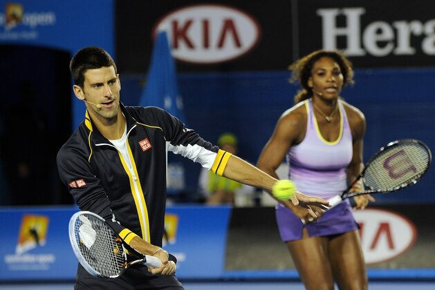 Novak Djokovic of Serbia (L) and Serena Williams of the US play during a Kids Day exhibition match ahead of the upcoming Australian Open tennis tournament in Melbourne on January 12, 2013.  The first Grand Slam tennis tournament of the year is set to run from January 14 to 27.    AFP PHOTO / MANAN VATSYAYANA
IMAGE STRICTLY RESTRICTED TO EDITORIAL USE - STRICTLY NO COMMERCIAL USE        (Photo credit should read MANAN VATSYAYANA/AFP/Getty Images)