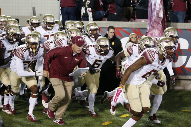 LOUISVILLE, KY - OCTOBER 30: Head coach Jimbo Fisher of the Florida State Seminoles leads his team to the field against the Louisville Cardinals before the game at Papa John's Cardinal Stadium on October 30, 2014 in Louisville, Kentucky. Florida State defeated Louisville 42-31. (Photo by Joe Robbins/Getty Images)