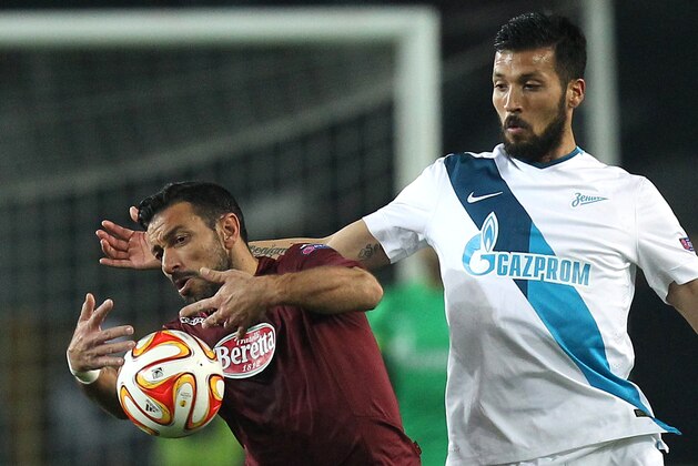 Torino's forward Fabio Quagliarella (L) fights for the ball with Zenit's Argentinian defender Ezequiel Garay during the UEFA Europa League round of 16 football match Torino Vs Zenit on March 19, 2015 at the 'Olympic Stadium' in Turin.  AFP PHOTO / MARCO BERTORELLO        (Photo credit should read MARCO BERTORELLO/AFP/Getty Images)