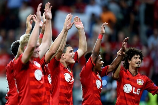 Leverkusen's players celebrate after the UEFA Champions League second leg playoff football match between Bayer Leverkusen and SS Lazio in Leverkusen, western Germany, on August 26, 2015.  Leverkusen wins 3-0. AFP PHOTO / PATRIK STOLLARZ        (Photo credit should read PATRIK STOLLARZ/AFP/Getty Images)